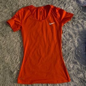 orangish-reddish nike t-shirt